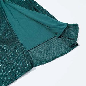 Close-up of dark green sequins on mesh fabric with soft lining for party dress