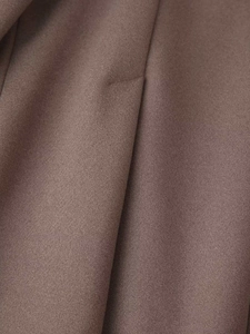 Close-up of premium brown wool blend fabric showing tight texture and matte finish