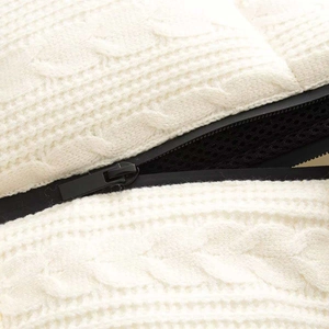 Detail view of cream cable knit texture with durable black zipper and mesh lining