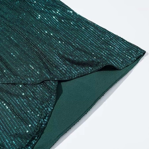 Deep green sequined long sleeve dress with slit detail for elegant evening wear