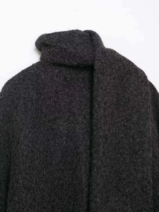 Close-up of high-quality dark grey plush faux fur fabric on a warm winter turtleneck coat