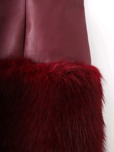 Detailed macro view showing premium burgundy leather stitched with fluffy faux fur texture