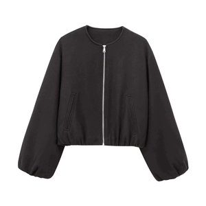 Detail of black wool bomber jacket featuring silver metal zipper and elastic hem