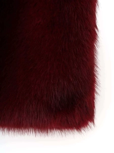 Macro detail of wine red faux fur texture showing soft plush fibers and silky shine