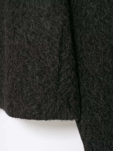 Close-up view of plush dark gray faux fur fabric texture for chic winter jacket
