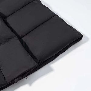 Détail de la doudoune noire avec surpiqûres carrées et curseur de fermeture éclair en métal