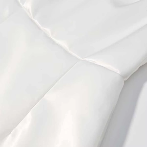Macro du tissu matelassé blanc montrant la texture élégante et les coutures lisses