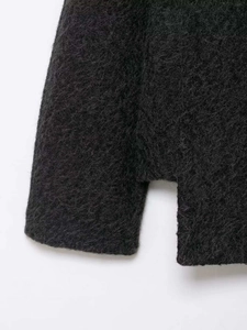 Close-up of charcoal grey plush faux fur fabric with elegant side split hem detail