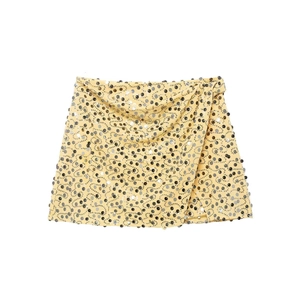 Chic light yellow mini skirt with silver and black sequins in a wrap design style