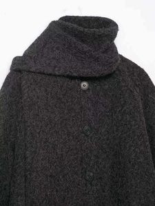 Detail shot of a dark grey fuzzy cardigan featuring high collar and round buttons