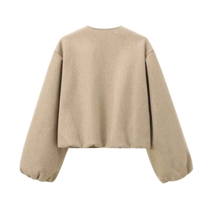 Detail view of the smooth back and lantern sleeves on a camel wool bomber jacket