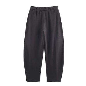 Detail view of the elastic waistband and drawstring on black loose-fit casual pants