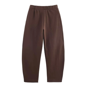 Detail of coffee brown casual trousers with elastic waistband and soft cotton fabric texture