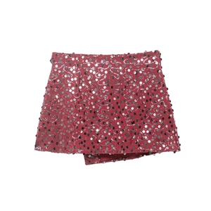 Detail of red mini skirt featuring silver sequins in wave patterns with wrap front
