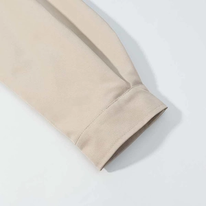 Detailed close-up showing durable stitching and high-quality beige cotton fabric cuff