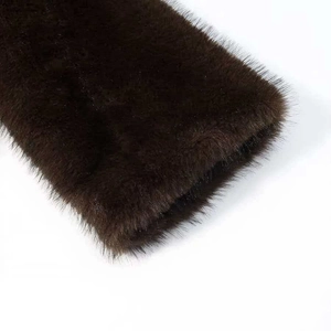 Detailed macro view of dense dark brown faux fur texture with soft glossy finish