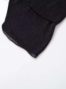 Detail of black mesh stitching and delicate overlock seam on irregular knitted dress