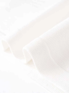 Detailed close-up showing the soft white knit fabric texture and fine stitching on the shirt
