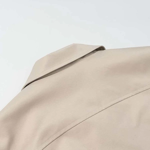 Detail view of beige jacket collar showing high-density cotton fabric and double stitching