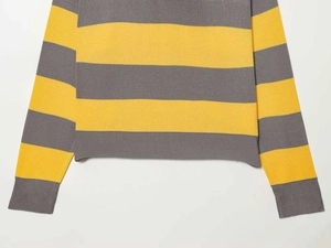 Detail of grey and yellow striped knit sweater showing ribbed cuffs and textured fabric