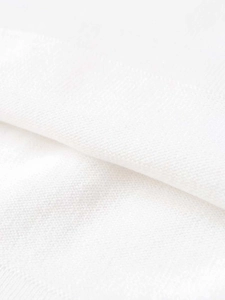 Macro shot of high-quality white knitted fabric texture with soft cotton weave details