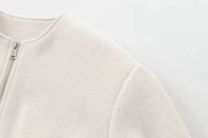 Detail of soft wool blend bomber jacket with high-quality silver metal zipper closure
