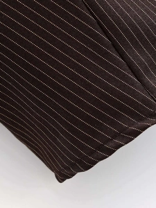 Macro shot of brown striped fabric texture with fine white dotted pinstripe detailing