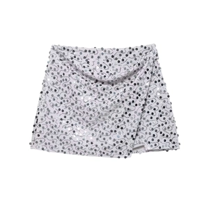 Close-up of the intricate silver sequins and wrap design on a mini party skirt