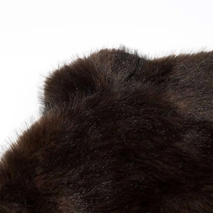 Detailed macro shot of deep brown faux fur texture and soft plush fibers on jacket