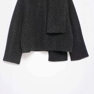 Short dark grey faux fur jacket with asymmetric cut and fuzzy plush texture