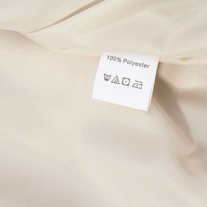 Detail of white 100% polyester fabric texture and care label for women jacket set