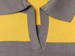 Detail of yellow and grey striped knit polo sweater collar showing fine texture