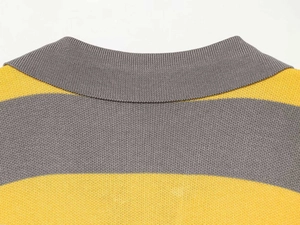 Detailed view of the striped knit collar and fine texture of the gray and yellow sweater