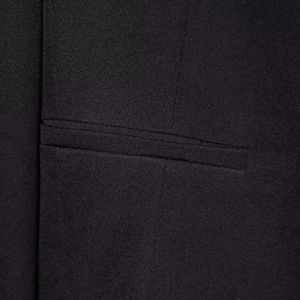 Detail shot of a neat welt pocket on a high-quality black woven short jacket