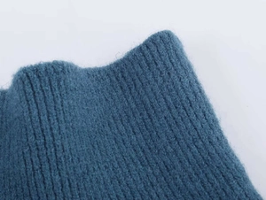 Detail of navy blue ribbed knit sweater showing the soft texture and neck finishing
