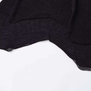 Chic black knitted mesh skirt featuring an irregular layered hem and sheer texture