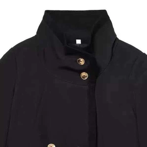 Minimalist black short jacket with stand collar and decorative gold metal buttons