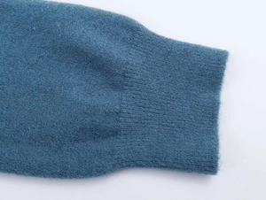 Detailed macro view of peacock blue knitted cashmere sweater ribbed cuffs texture