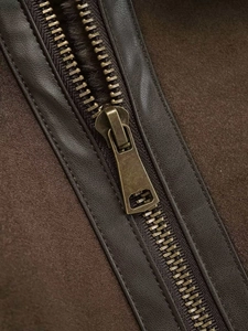 Close-up of vintage brown faux shearling jacket with bronze zipper and warm lining