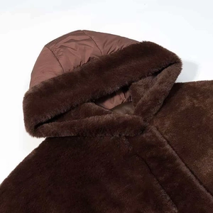 Detail of soft dark brown faux fur hood and smooth inner lining for winter warmth