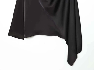 Detail of black satin long sleeve shirt featuring irregular hemline and smooth texture