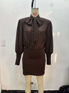 Detail view of brown chiffon bow-tie shirt with lantern sleeves and fitted mini skirt