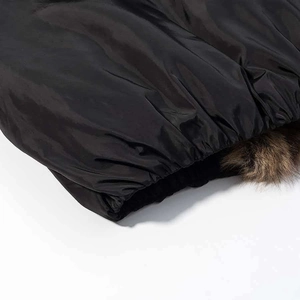Detail of winter jacket hem featuring black satin finish and soft brown faux fur lining