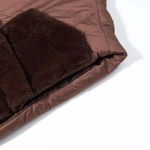 Close-up of brown quilted fabric with plush faux fur trim on winter cotton jacket