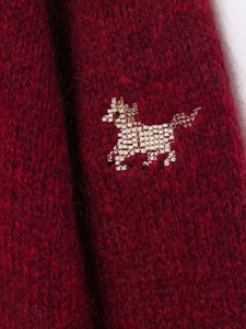 Detailed view of white beaded horse embroidery on a dark red mohair knit cardigan