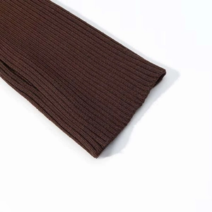 Macro shot of dark chocolate brown ribbed knit texture on long sleeve winter jacket cuffs