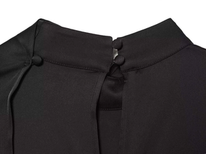 Detail of black satin shirt featuring a mandarin collar and matching cloth-covered buttons