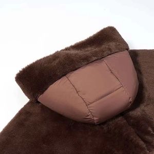 Close-up of winter quilted jacket with warm dark brown faux fur and stitching details