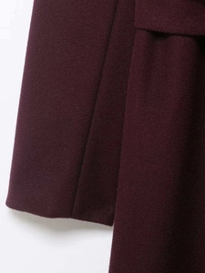 Macro shot of high-quality wool fabric texture and fine stitching on burgundy coat