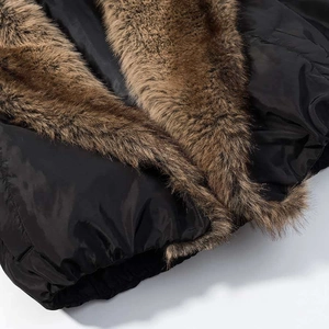 Detail of winter jacket featuring a large brown faux fur collar and windproof black fabric